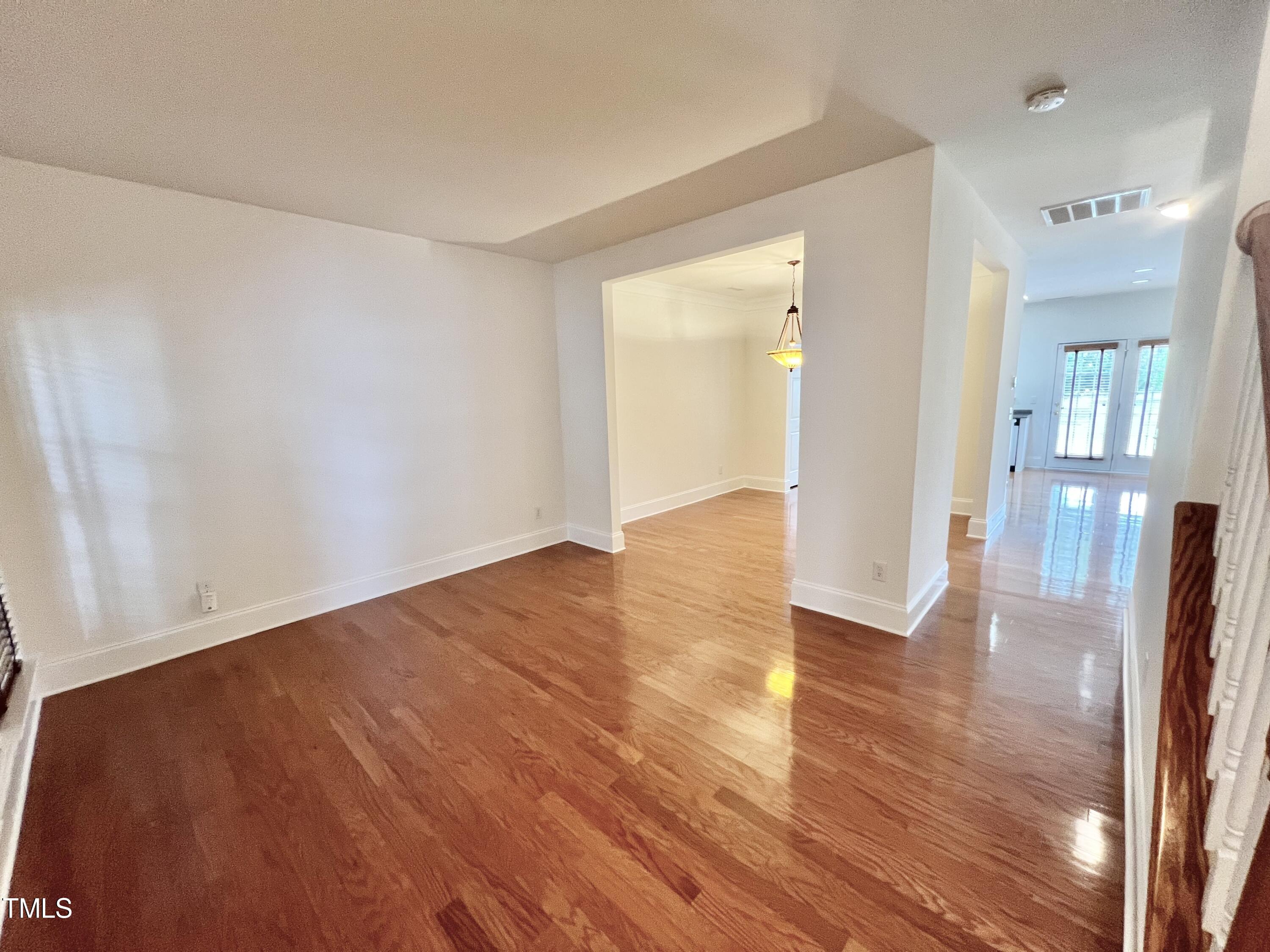 12221 Fox Valley Street Raleigh, NC 27614 - Photo 4 of 29 a view of a room with wooden floor and a bathroom