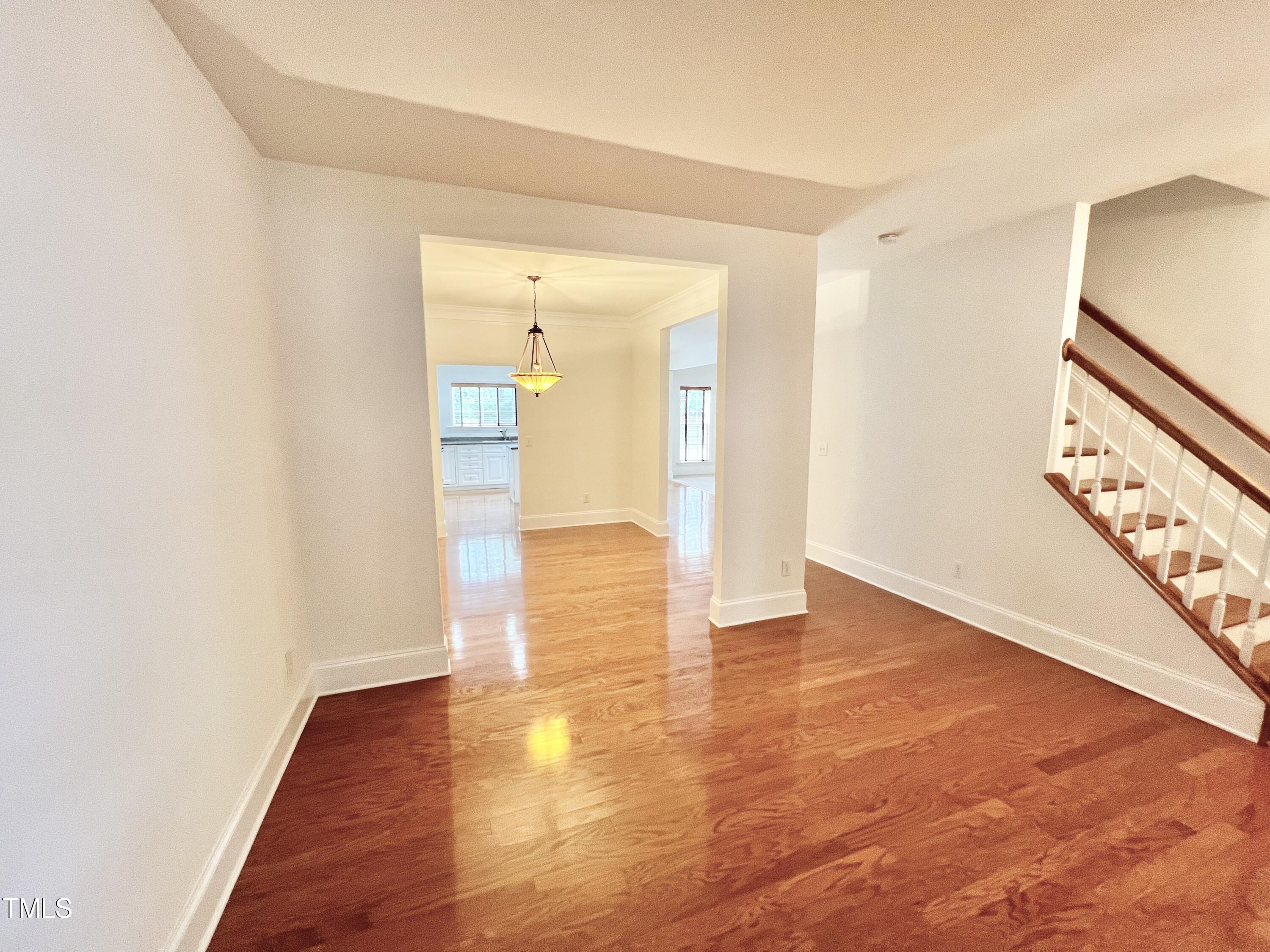 12221 Fox Valley Street Raleigh, NC 27614 - Photo 6 of 29 a view of a hallway with wooden floor