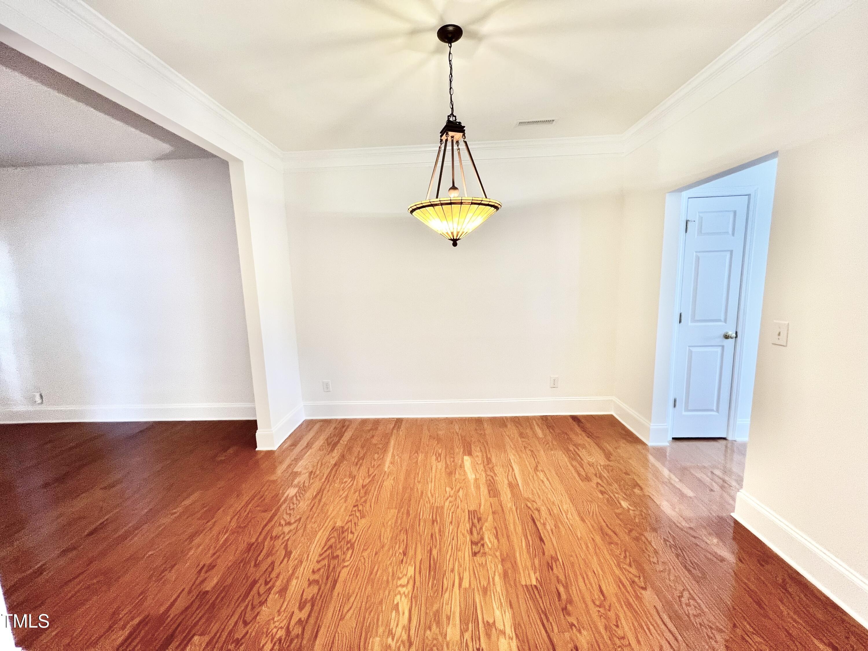 12221 Fox Valley Street Raleigh, NC 27614 - Photo 8 of 29 a view of empty room with wooden floor and window