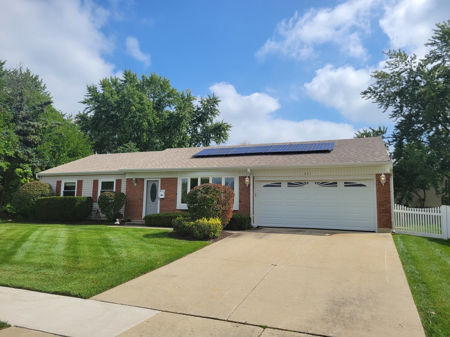 a front view of house with yard and green space