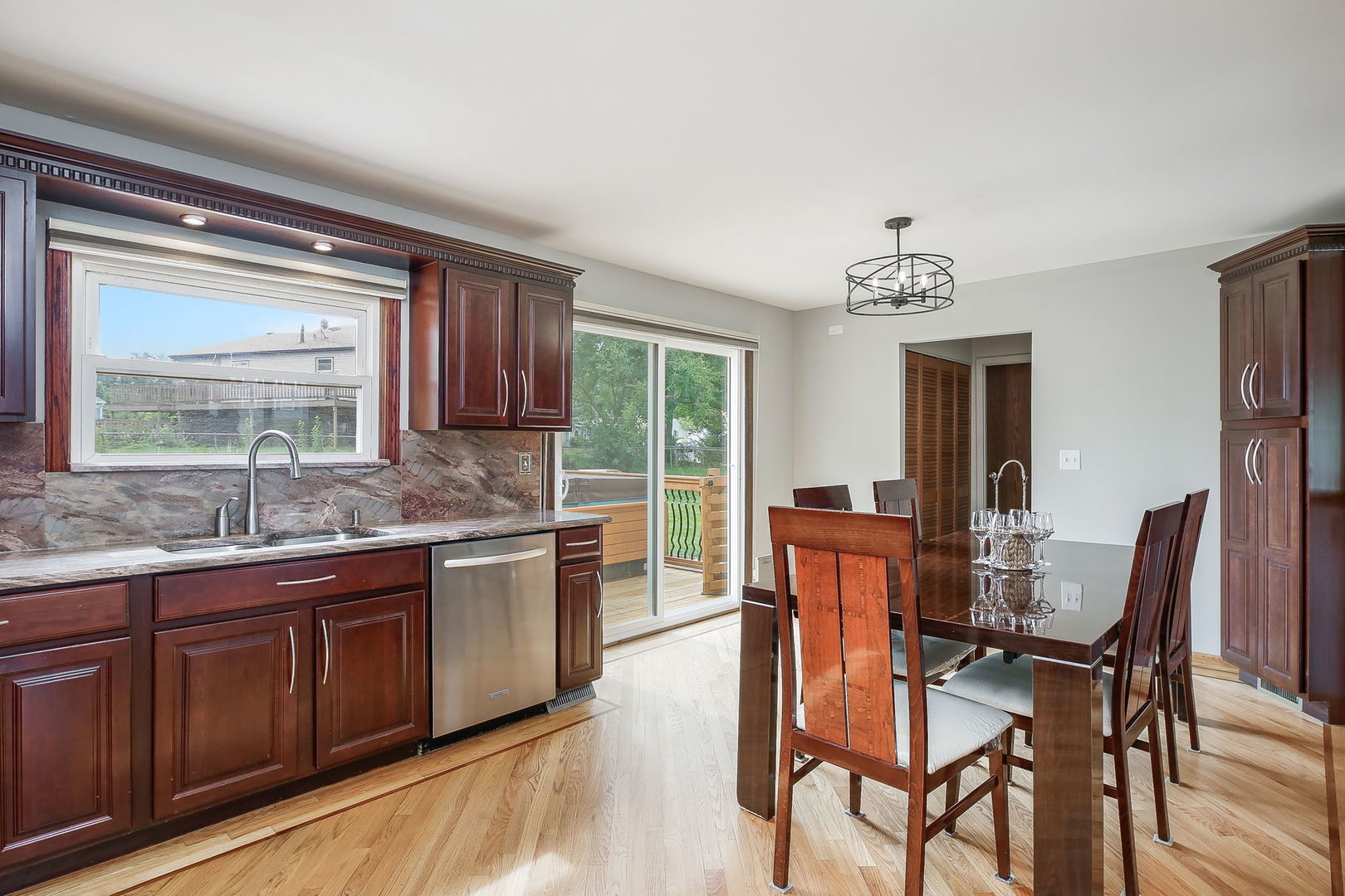 421 North Braintree Drive Schaumburg, IL 60169 - Photo 13 of 23 a dining hall with stainless steel appliances granite countertop a kitchen island a stove a table and chairs in it