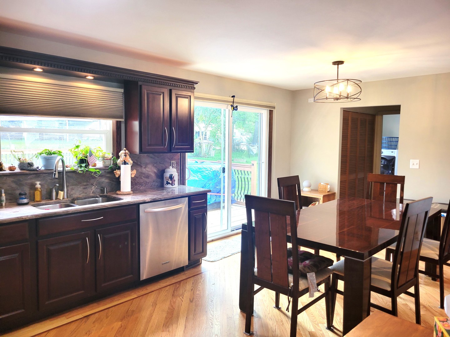 421 North Braintree Drive Schaumburg, IL 60169 - Photo 7 of 23 a kitchen with granite countertop wooden floor dining table and chairs