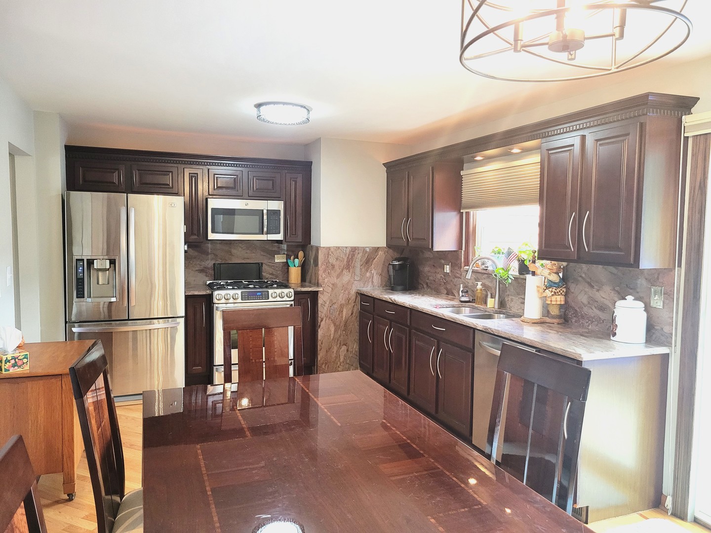 421 North Braintree Drive Schaumburg, IL 60169 - Photo 9 of 23 a kitchen with stainless steel appliances granite countertop a refrigerator and a stove top oven
