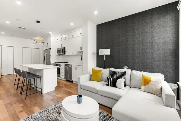 a living room with furniture and a dining table