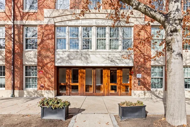 a front view of a building with a garden