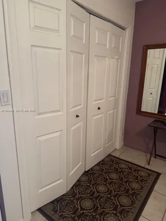 a room with wooden floor and white doors