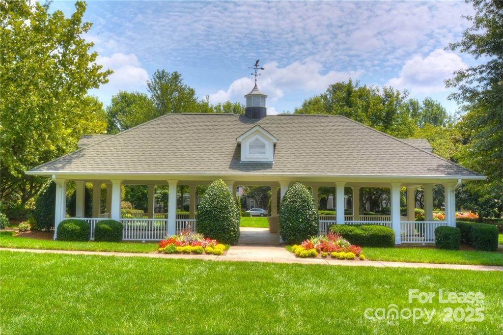 17905 Delmas Drive, Unit 101 Cornelius, NC 28031 - Photo 17 of 17 a front view of a house with a yard table and chairs
