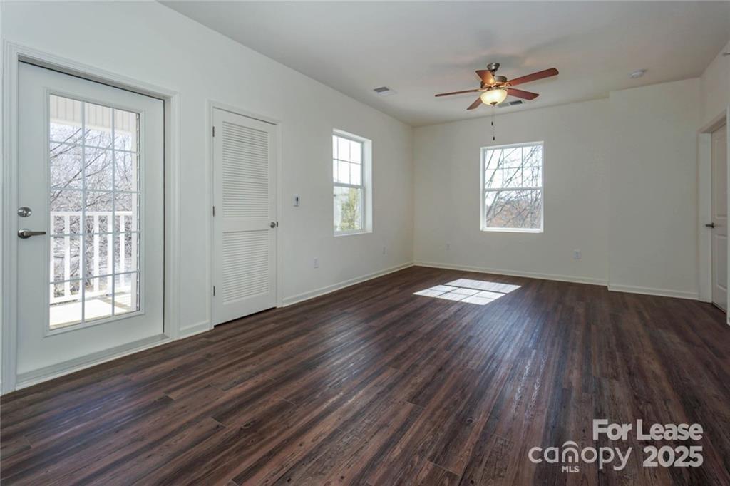 17905 Delmas Drive, Unit 101 Cornelius, NC 28031 - Photo 4 of 17 a view of an empty room with wooden floor and a window