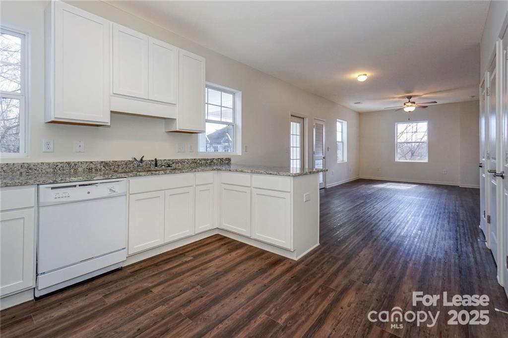 17905 Delmas Drive, Unit 101 Cornelius, NC 28031 - Photo 6 of 17 a kitchen with a hard wood floor window and a sink
