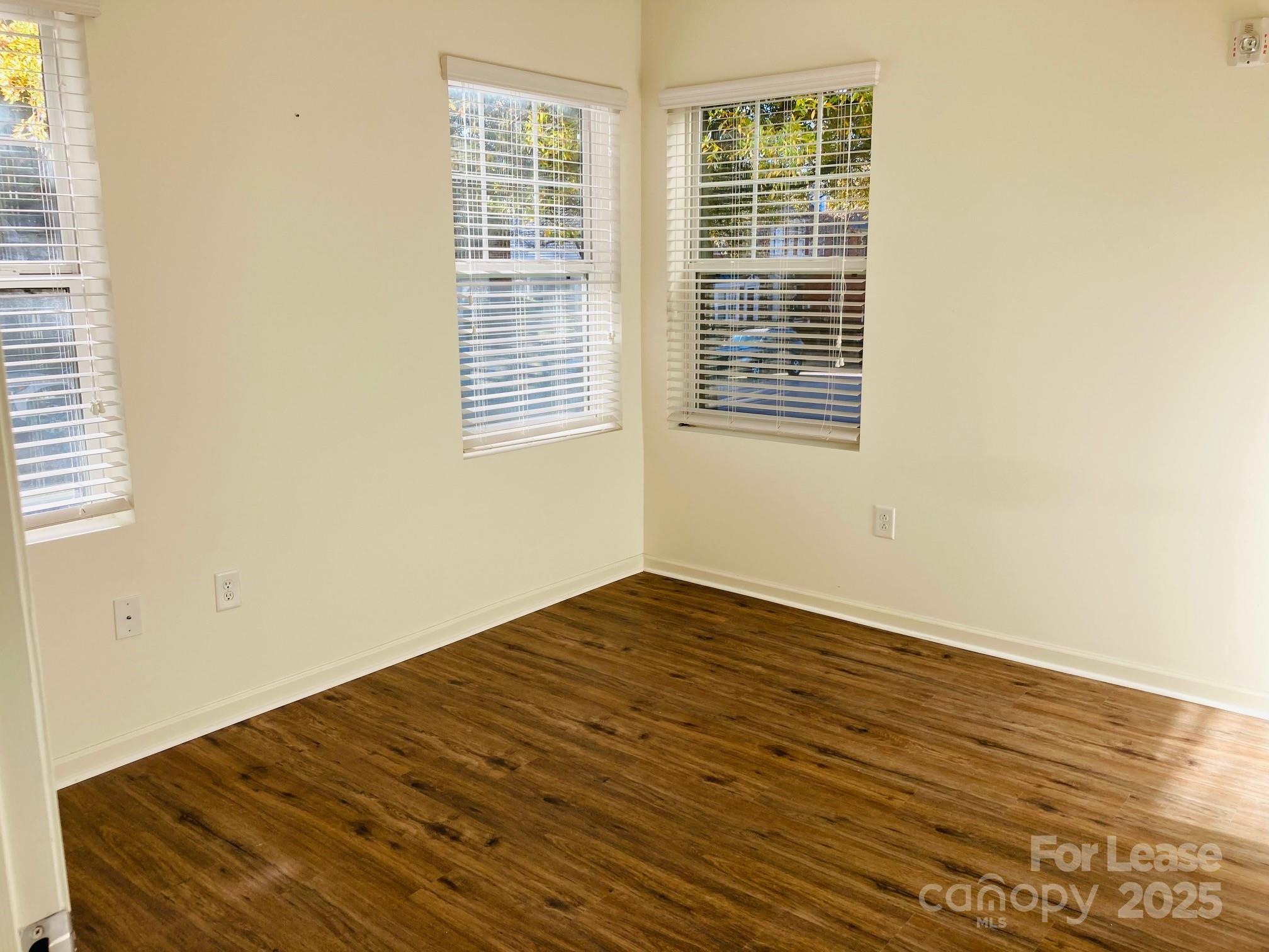 17905 Delmas Drive, Unit 101 Cornelius, NC 28031 - Photo 8 of 17 a view of empty room with wooden floor and fan