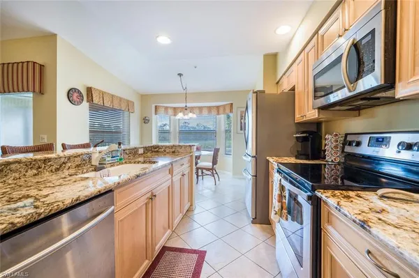 a kitchen with stainless steel appliances granite countertop a stove and a sink