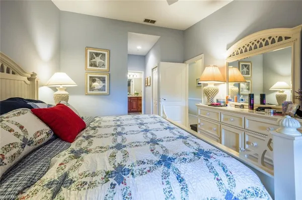 a bedroom with a bed and a mirror