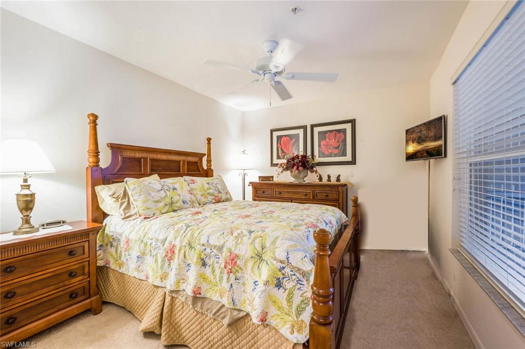 7635 Arbor Lake Court, Unit 2423 Naples, FL 34112 - Photo 19 of 50 a bed room with a bed and a night stand