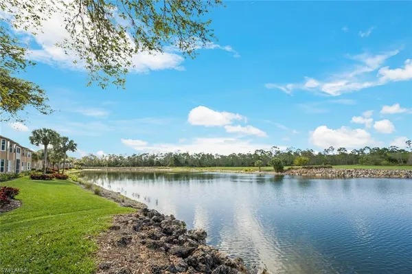 a view of a lake with houses in the back