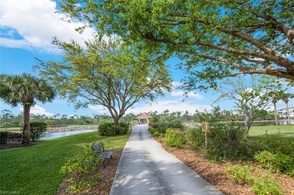 7635 Arbor Lake Court, Unit 2423 Naples, FL 34112 - Photo 26 of 50 a view of a street with a yard and large trees