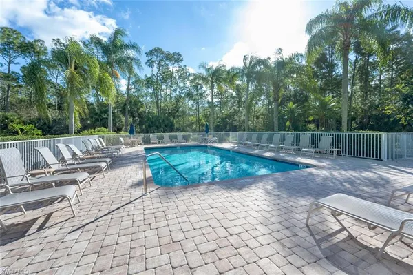 a swimming pool with outdoor seating and yard