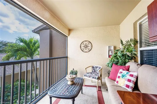 a view of a chairs and table in the balcony