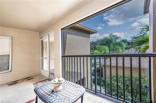 a balcony view with a backyard space
