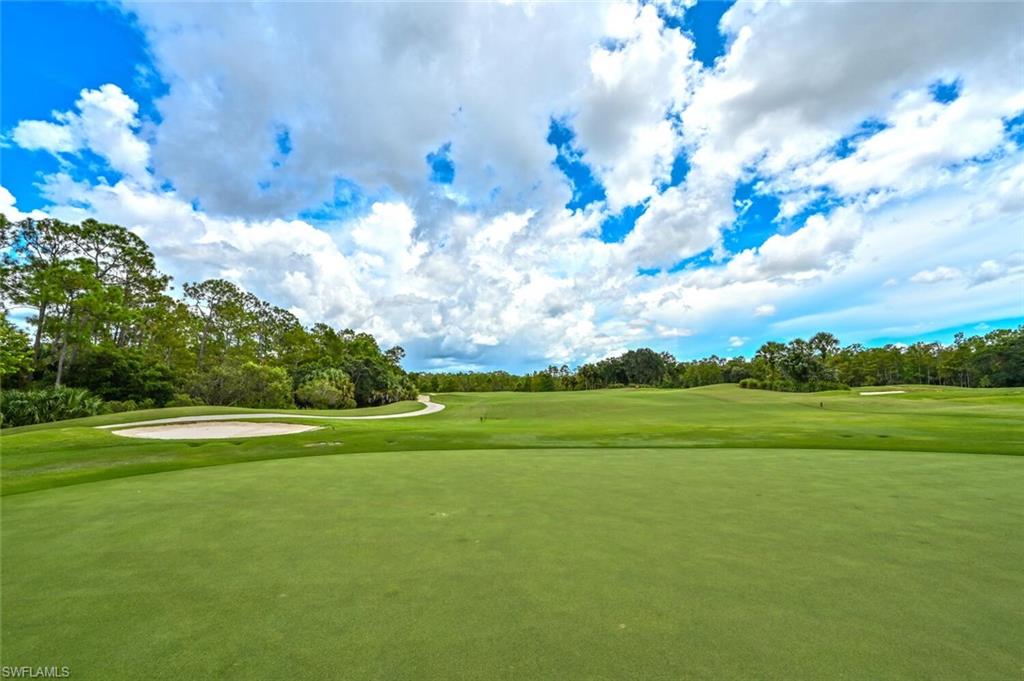 7635 Arbor Lake Court, Unit 2423 Naples, FL 34112 - Photo 45 of 50 a view of a golf course with a lake