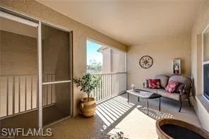 a living room with furniture fireplace and a large window