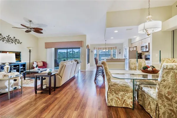 a living room with furniture wooden floor and a chandelier