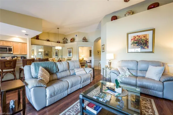 a living room with furniture kitchen view and a dining table