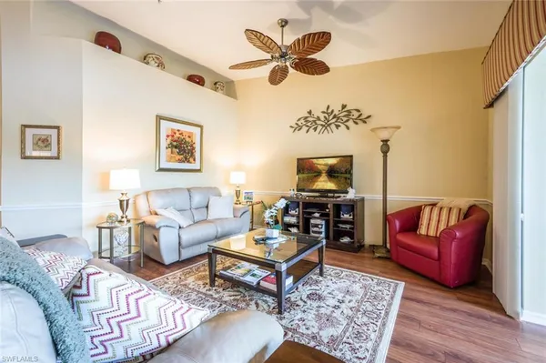 a living room with furniture a rug and a window