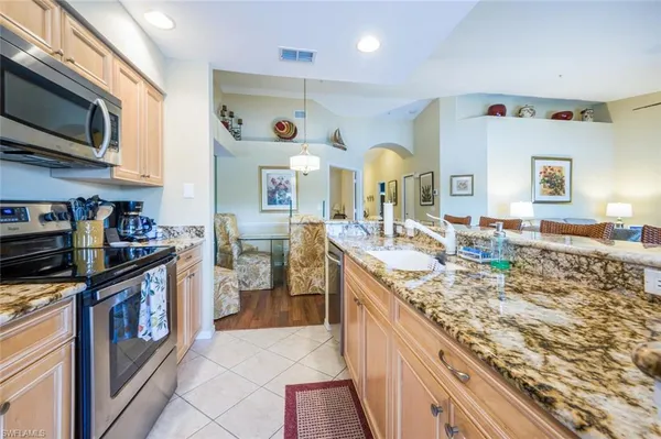 a kitchen with stainless steel appliances granite countertop a stove and a sink