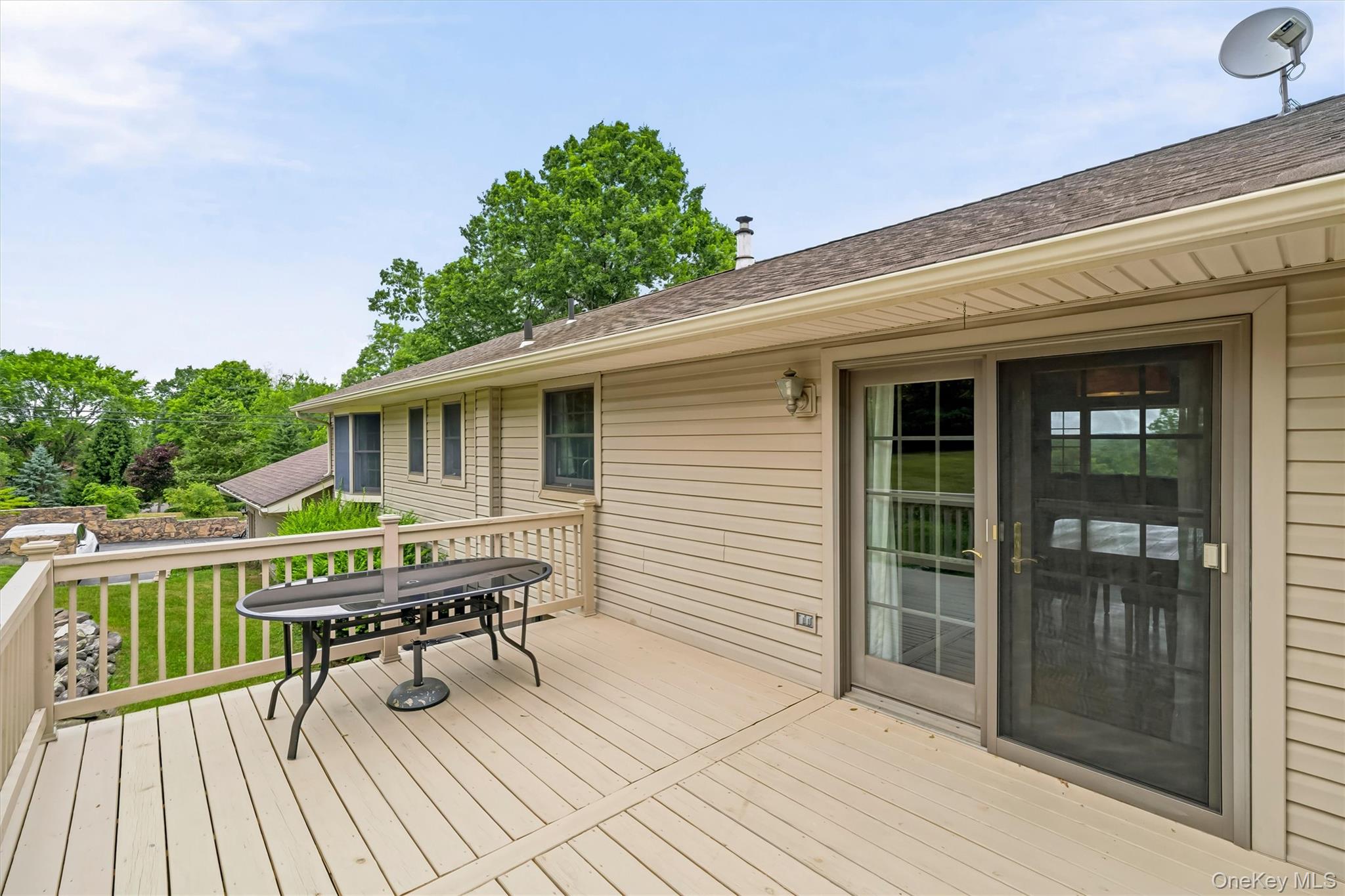 318 Beattie Road Washingtonville, NY 10992 - Photo 30 of 42 a balcony with wooden floor table and chairs
