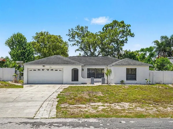 a house that has a tree in front of it