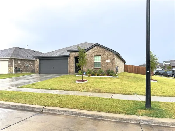 a view of a house with a yard and a garage