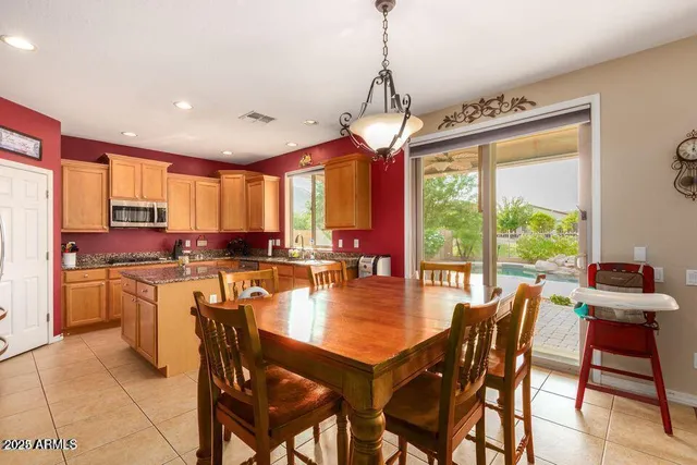 a view of a dining room and livingroom with furniture wooden floor a chandelier