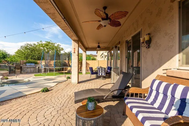 a view of a patio with a dining table and chairs