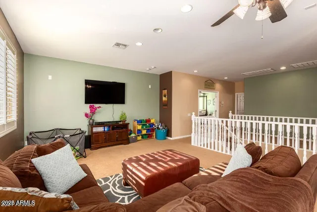 a bedroom with furniture and a flat screen tv