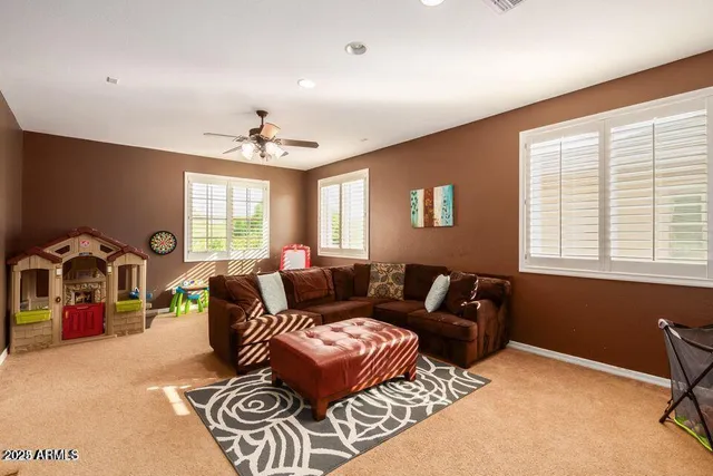 a living room with furniture a chandelier and a window