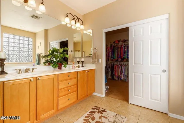 a spacious bathroom with a double vanity sink and a mirror