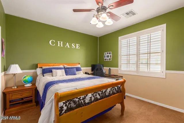 a bedroom with a bed and a window