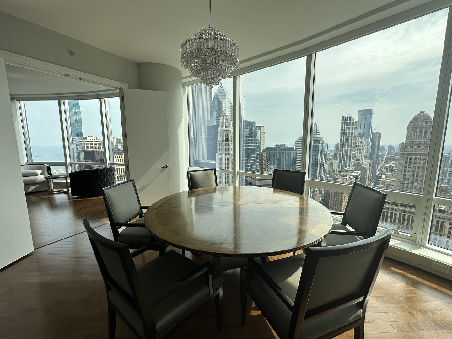 401 North Wabash Avenue, Unit 32H Chicago, IL 60611 - Photo 13 of 16 a dining room with furniture a chandelier and wooden floor
