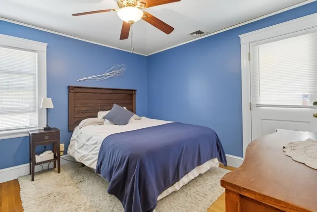 a bedroom with a bed and window