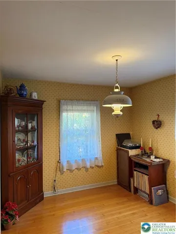 a view of bedroom with wooden floor
