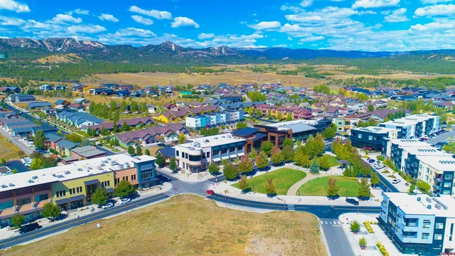 a view of a swimming pool with a yard and mountain view in back
