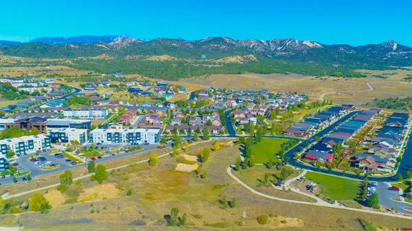 a view of a yard with a house in the background