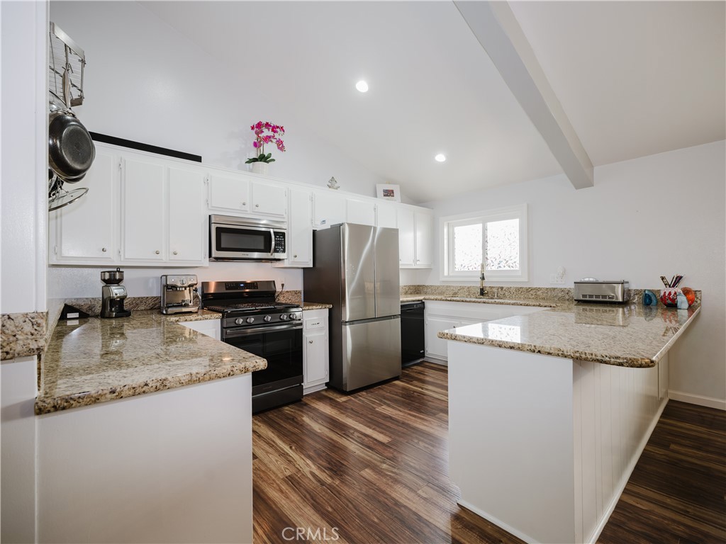 5330 Seabreeze Way Oxnard, CA 93035 - Photo 13 of 38 a kitchen with a sink microwave and refrigerator