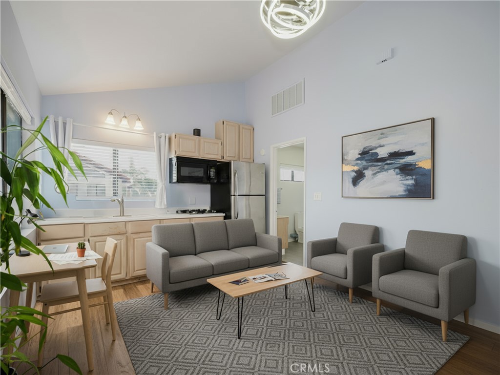 5330 Seabreeze Way Oxnard, CA 93035 - Photo 16 of 38 a living room with furniture a rug kitchen view and a table