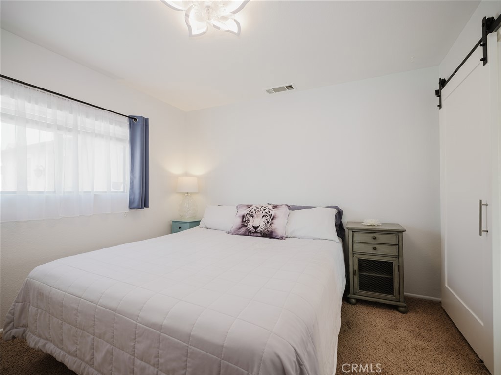 5330 Seabreeze Way Oxnard, CA 93035 - Photo 22 of 38 a bedroom with a bed and a window