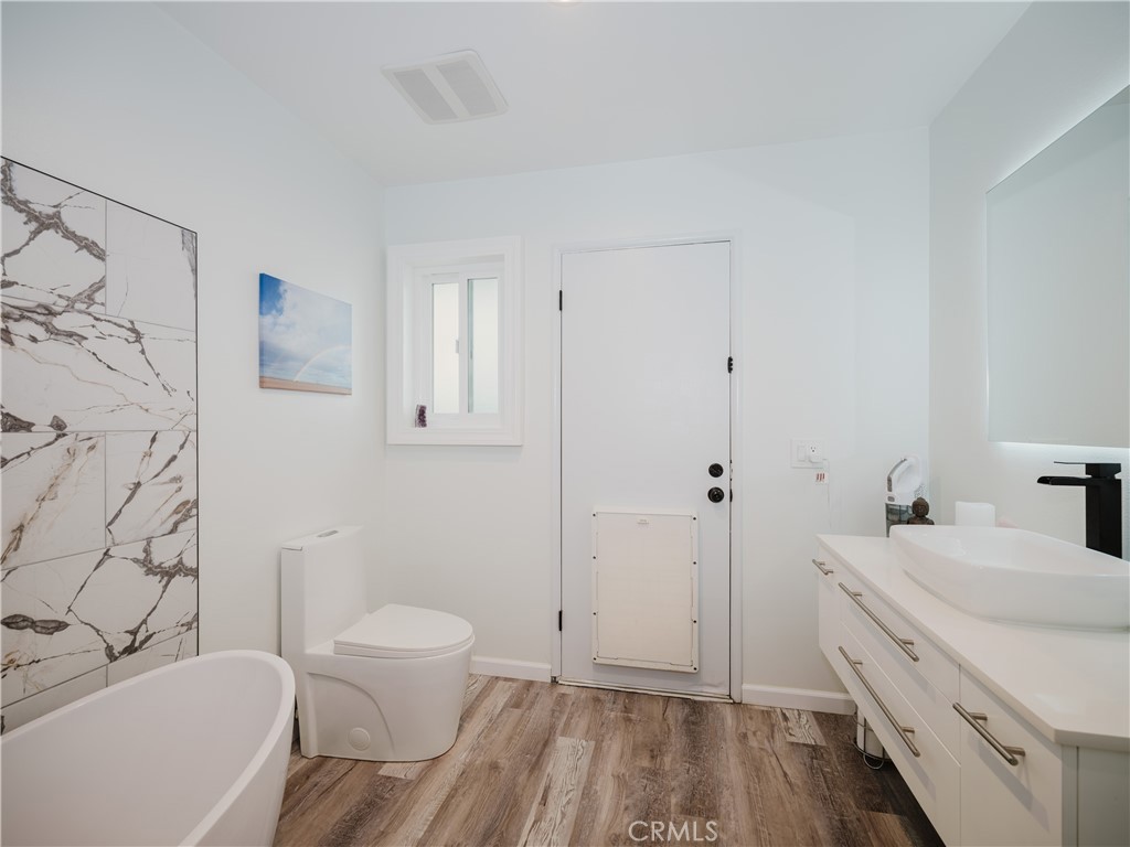5330 Seabreeze Way Oxnard, CA 93035 - Photo 25 of 38 a bathroom with a granite countertop sink toilet and shower