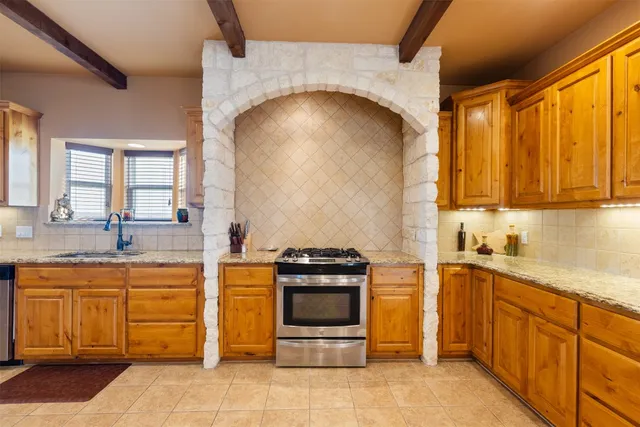 a kitchen with stainless steel appliances granite countertop a stove and a sink