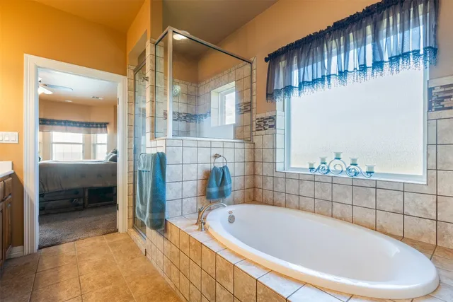 a bathroom with a bathtub and a shower