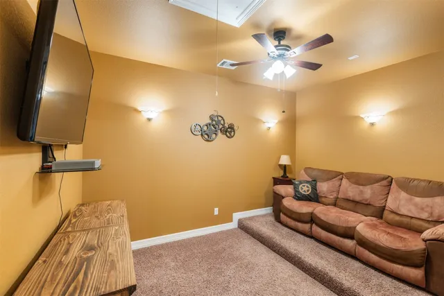 a living room with couch and a ceiling fan