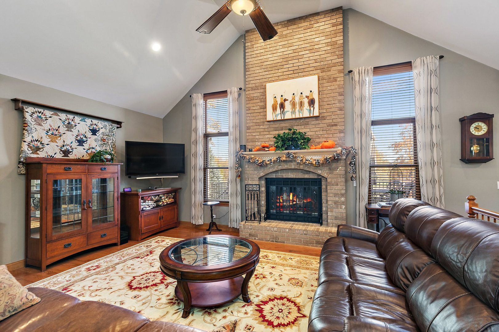 8908 South Hill Road Marengo, IL 60152 - Photo 33 of 53 a living room with furniture a flat screen tv and a fireplace